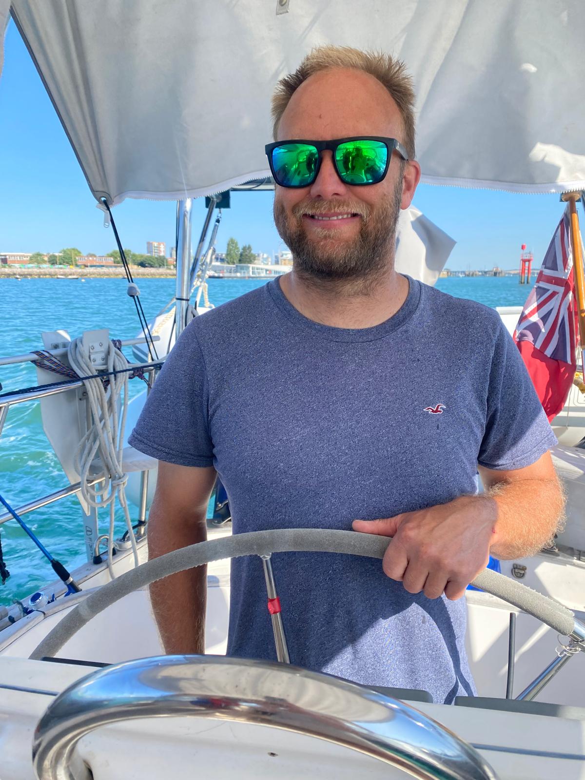 Henry Saunders, founder of Freedom Under Sail, at the helm aboard Suerte